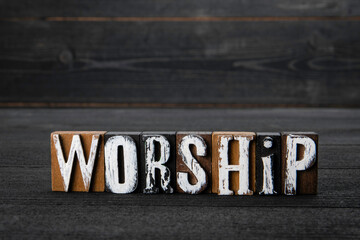 Worship. Wooden alphabet letters on a dark background