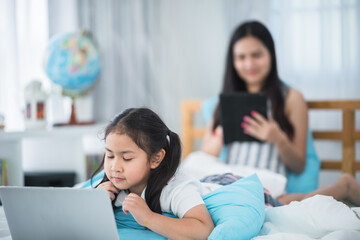 Fototapeta premium mother teaching child girl for doing homework at home, family education activity concept