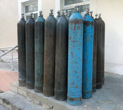A lot of oxygen cylinders are on the porch of the hospital for patients