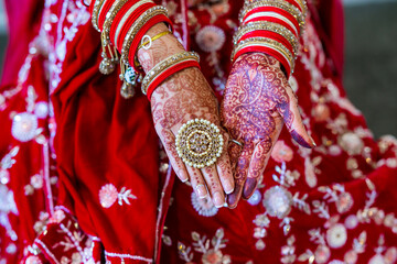 Indian bride's wearing her wedding jewellery hands close up
