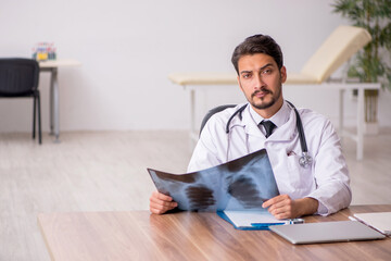Young male doctor radiologist sitting in the clinic