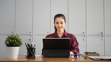 Attractive businesswoman working with computer tablet in office.