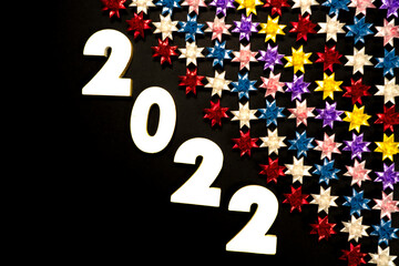 Obraz na płótnie Canvas Number 2020 with Floding paper stars on Black background.