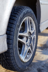Silver car and wheel with winter rubber studded
