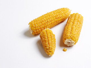 Yellow corn seeds on the cob several pieces on a white background
