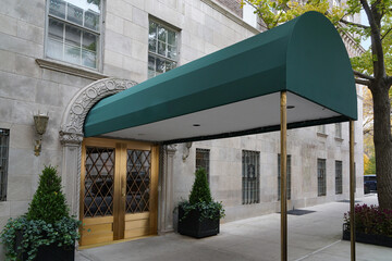 Manhattan elegant upscale apartment building and awning leading from front door to street