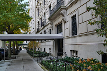 Manhattan elegant upscale apartment buildings and awning leading from front door to street