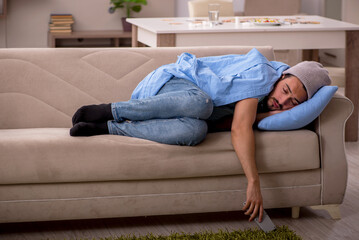 Fototapeta premium Young man suffering at home
