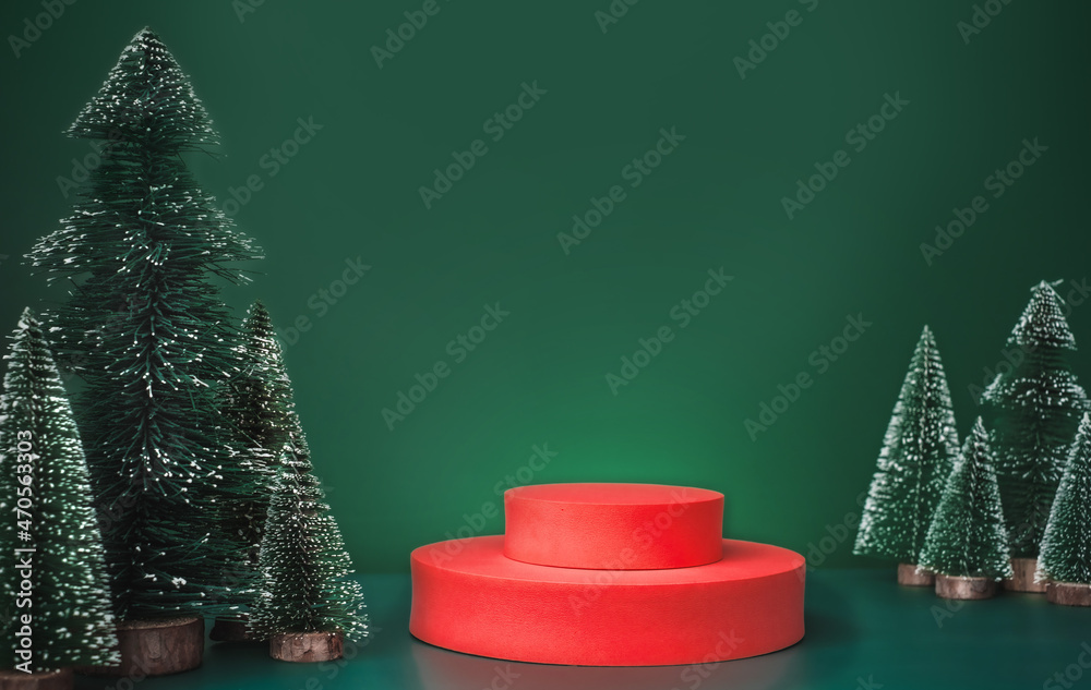 Poster christmas tree group and red vivid product display block on green background.