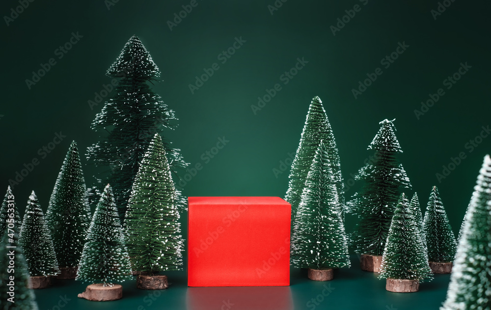 Poster christmas tree group and red vivid product display block on green background.