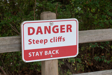View of sign Danger Steep Cliffs Stay Back on the Wreck Beach in Vancouver, Canada