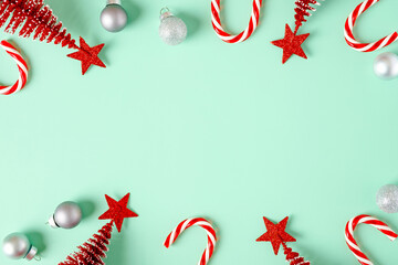 top view christmas ornament xmas tree,candy cane,bauble decor on pastel green background