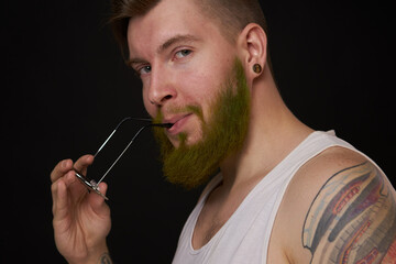bearded man in white t-shirt with tattoos on his arms posing bully