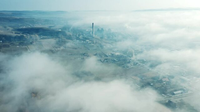 Aerial view of industrial zone covered with autumn fog in Dej, Romania.