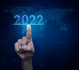 Hand pressing 2022 text over digital world map technology style, Business happy new year 2022 cover concept, Elements of this image furnished by NASA