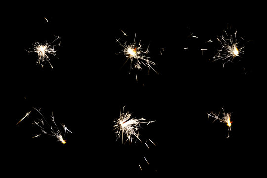 6 pack of celebration Sparklers Isolated on black background. Sparklers sparks from burning Pyrotechnics on Black overlay. Orange celebration fireworks Glitter lights for party and event designs.
