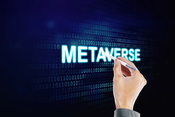 Man hand writes metaverse word with a stylus pen