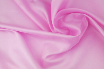 Obraz premium Pink satin fabric background. Wedding backdrop or holidays design element.