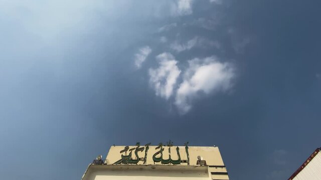 Blue Sky And Clouds With Slow Tilt Down Reveal To Entrance Sign To Baitul Mukarram National Mosque