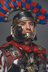 Headshot of isolated on gray roman warrior with plumed helmet