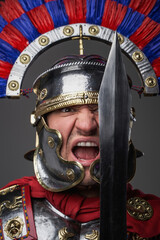 Screaming legionary with short sword against gray background