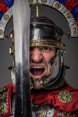 Screaming legionary with short sword against gray background