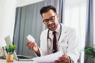 Portrait of a smiling doctor giving prescription to patient
