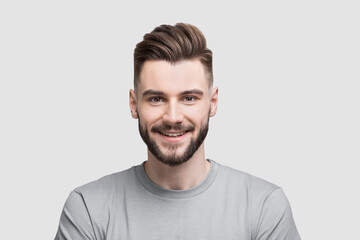 Closeup portrait of handsome smiling young man. Laughing joyful cheerful men studio isolated shot