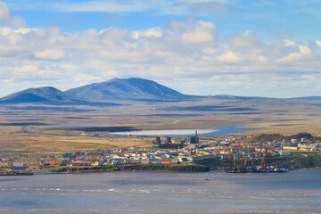 Fototapeta na wymiar Summer aerial view of the northern arctic port town. Small town in the tundra on the coast. Anadyr is the administrative center of Chukotka and the easternmost city in Russia. Beautiful landscape.