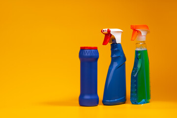 House cleaning detergent bottles on a yellow background