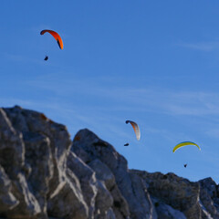 Paraglider flying over mountains in summer day in front of the mountain, High quality photo