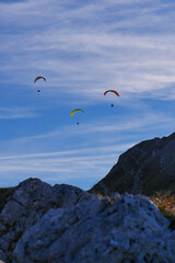 Paraglider flying over mountains in summer day in front of the mountain, High quality photo