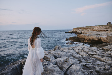 Fototapeta na wymiar Beautiful woman white dress standing outdoor Lifestyle unaltered
