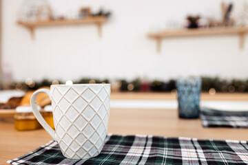 White cup of coffee on a wooden table