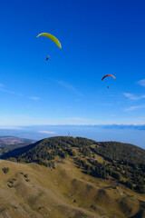Paraglider flying over mountains in summer day in front of the mountain, High quality photo