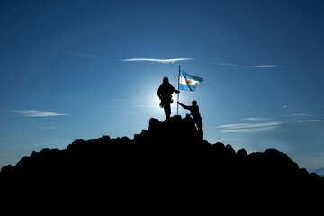 Fototapeta na wymiar Two soldiers raise the Argentine flag