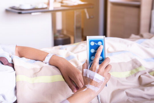 Patient woman hands using remote control for adjust level sickbed at hospital