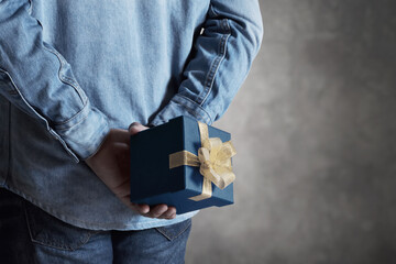 Young man holding gift box