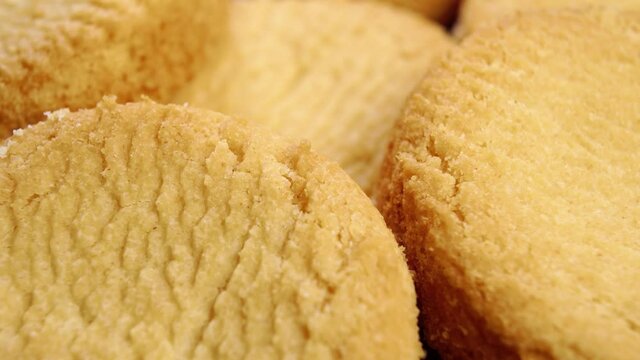 Baked shortbread cookie texture. Fresh round biscuits. Macro. Slow rotation