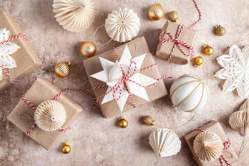 Christmas gift boxes decorated with snowflakes made of paper.