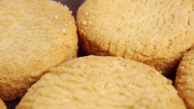 Stacked round shortbread biscuits. Macro. Slow rotation. Fresh homemade cookies