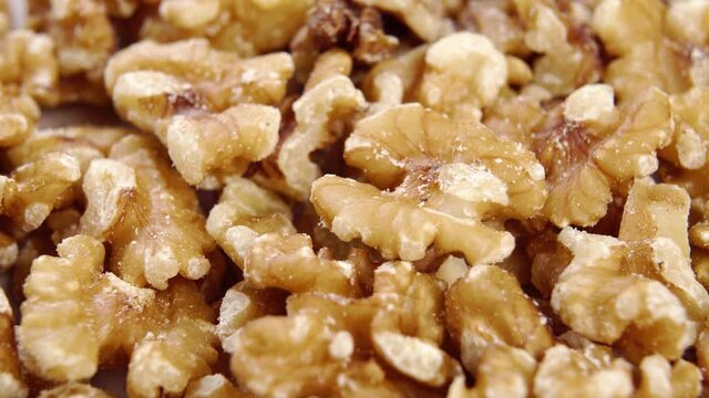 Peeled raw walnut. Dry nut kernels. Macro. Slow rotation. Dietary fatty food concept