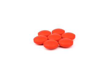 Red pills on a white background, isolated. Pharmacy. Treatment.