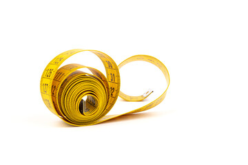 Yellow measuring tape spiral, isolated on white background.