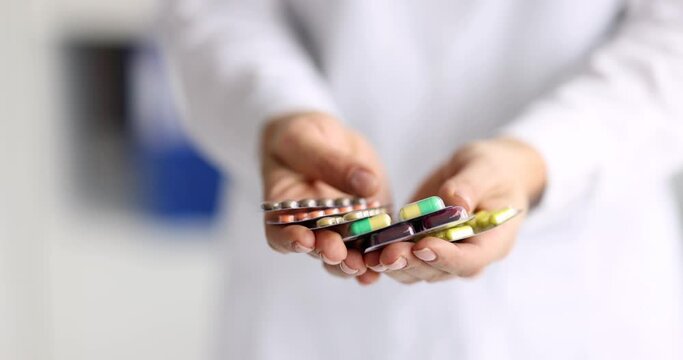 Doctor holding many blisters with capsules in his hands closeup 4k movie slow motion