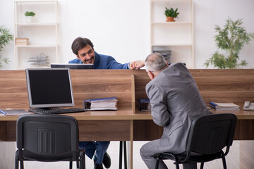 Two male employees working in the office