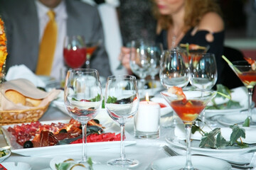 Holiday table setting decorated with flowers and candles.