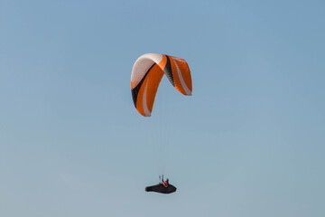 Single paraglider in the blue sky