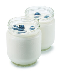 Two glass containers with plain yoghurt and berries isolated on white background. Clipping path.