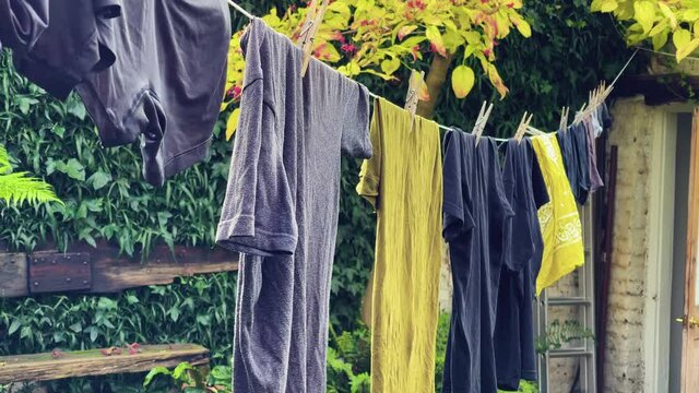 Mens clothing hangs to dry on a clothing line in London England.